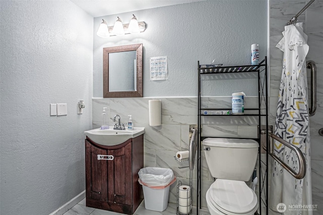 22901 114th Way SE, Kent, WA 98031 - full bathroom with vanity, toilet, a textured wall, a shower with shower curtain, and tile walls