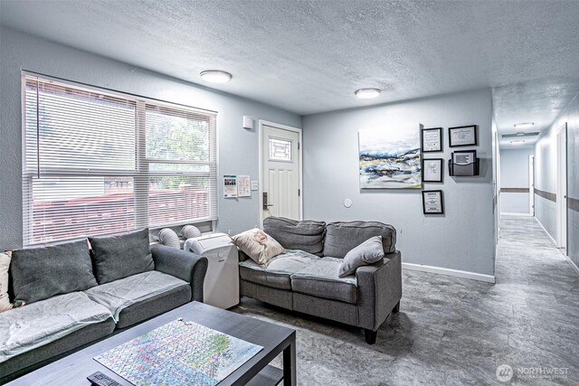 22901 114th Way SE, Kent, WA 98031 - living area featuring a textured ceiling, a textured wall, and baseboards