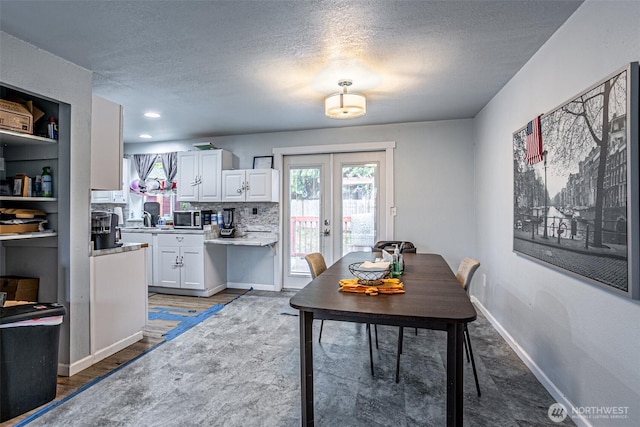 22901 114th Way SE, Kent, WA 98031 - dining room featuring french doors, a textured ceiling, and baseboards