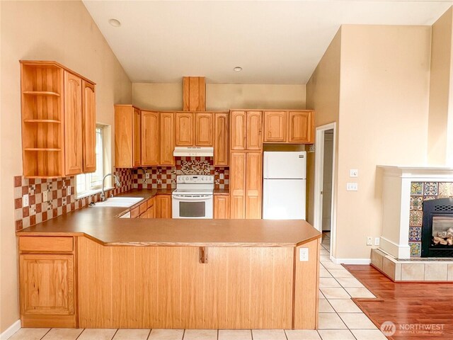 1304 Rosecrans St, Port Townsend, WA 98368 - kitchen featuring white appliances, a sink, under cabinet range hood, open shelves, and a peninsula