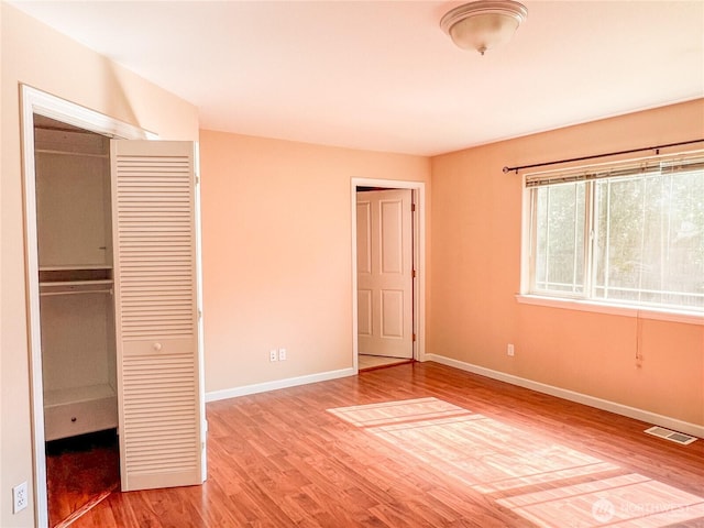 1304 Rosecrans St, Port Townsend, WA 98368 - unfurnished bedroom with a closet, wood finished floors, and baseboards