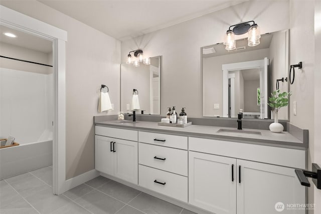 2446 64th Ave NW, Olympia, WA 98502 - bathroom with double vanity, shower / washtub combination, tile patterned flooring, and baseboards
