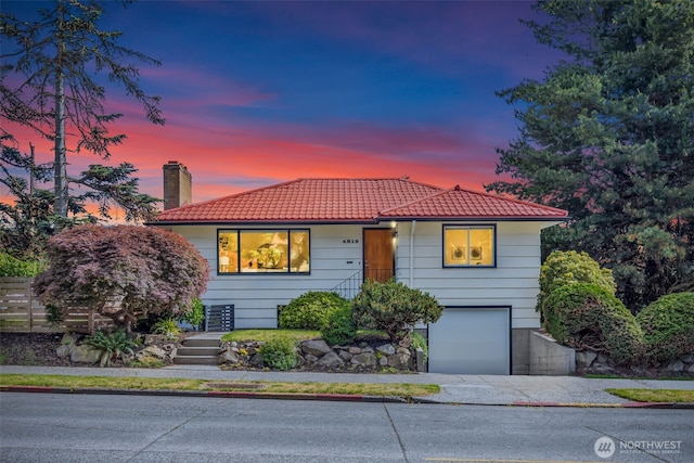 4619 SW Genesee St, Seattle, WA 98116 - view of front of home with a tiled roof, an attached garage, a chimney, and driveway