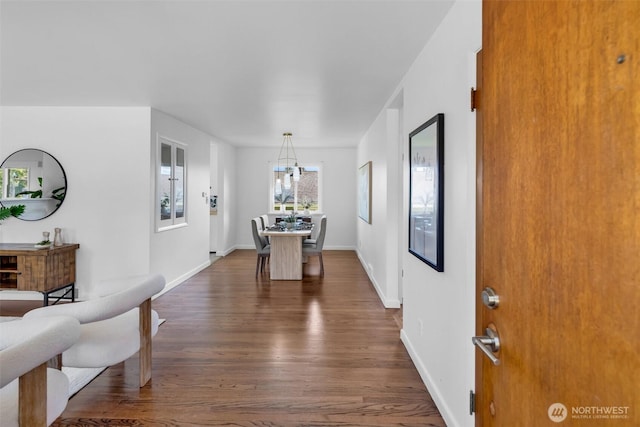 4619 SW Genesee St, Seattle, WA 98116 - dining area featuring dark wood finished floors, a chandelier, and baseboards