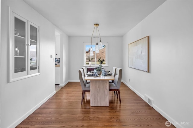 4619 SW Genesee St, Seattle, WA 98116 - dining room featuring dark wood-type flooring and baseboards