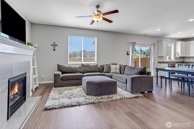 924 Livernash St, Buckley, WA 98321 - living room with light wood finished floors, ceiling fan, recessed lighting, a fireplace, and baseboards