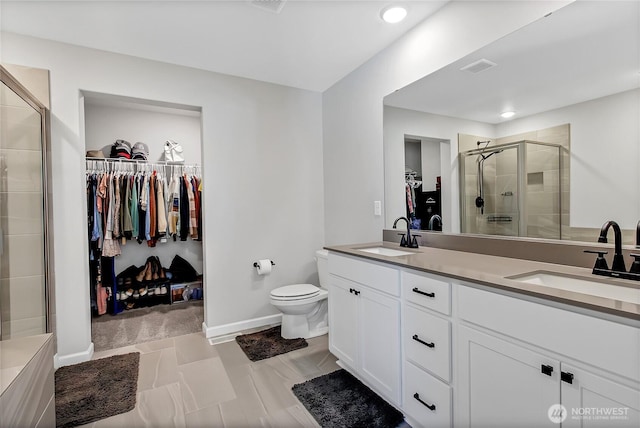 924 Livernash St, Buckley, WA 98321 - full bathroom with a spacious closet, double vanity, a stall shower, toilet, and baseboards