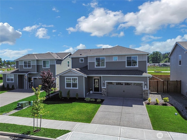 924 Livernash St, Buckley, WA 98321 - view of front of home featuring driveway, an attached garage, a residential view, and stone siding