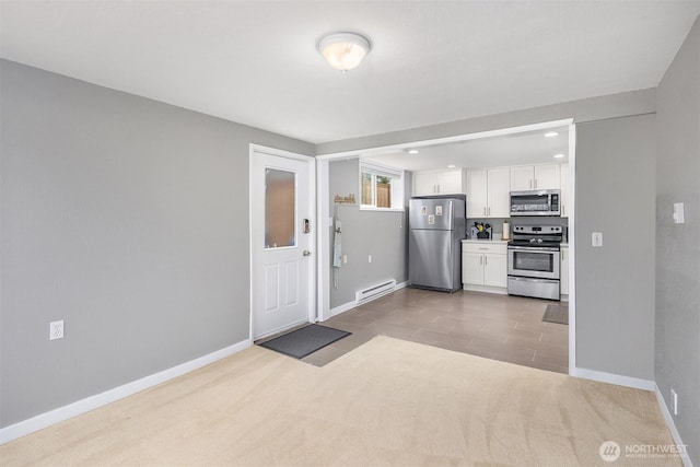 18312 73rd Ave W, Edmonds, WA 98026 - kitchen with stainless steel appliances, baseboard heating, white cabinetry, baseboards, and recessed lighting