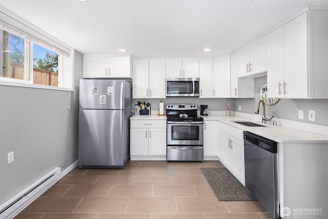 18312 73rd Ave W, Edmonds, WA 98026 - kitchen featuring appliances with stainless steel finishes, a baseboard heating unit, a sink, white cabinetry, and recessed lighting