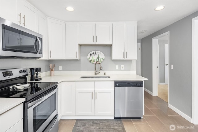 18312 73rd Ave W, Edmonds, WA 98026 - kitchen with appliances with stainless steel finishes, a sink, white cabinets, light countertops, and recessed lighting