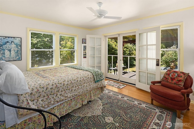 6045 Seward Park Ave S, Seattle, WA 98118 - bedroom with french doors, access to outside, wood finished floors, multiple windows, and ornamental molding