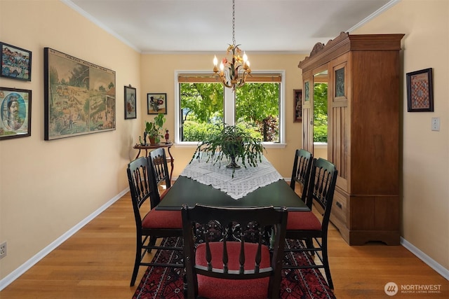 6045 Seward Park Ave S, Seattle, WA 98118 - dining area featuring a chandelier, light wood-style floors, and crown molding