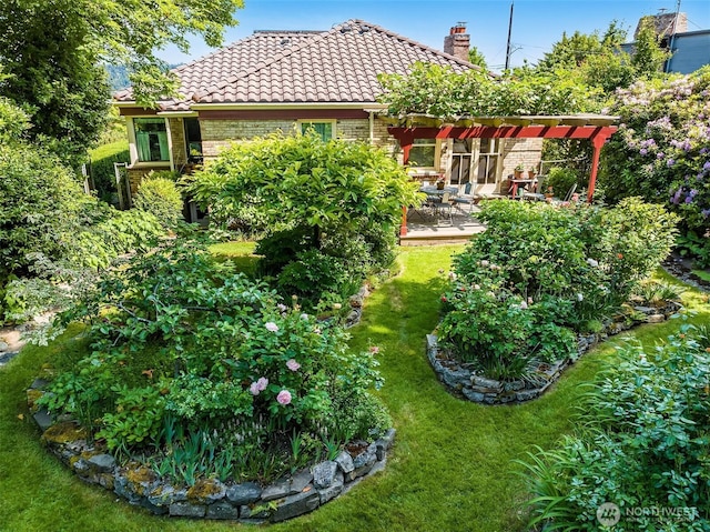 6045 Seward Park Ave S, Seattle, WA 98118 - rear view of property featuring a tile roof, brick siding, a lawn, a chimney, and a patio