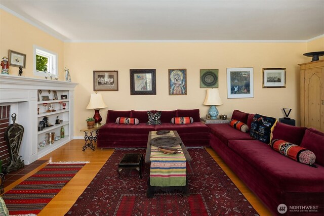 6045 Seward Park Ave S, Seattle, WA 98118 - living area featuring wood finished floors, ornamental molding, and a brick fireplace