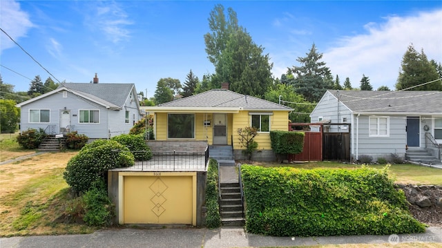 8608 16th Ave SW, Seattle, WA 98106 - bungalow-style house with an attached garage, stairs, and entry steps