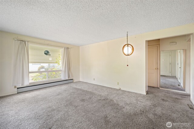 8608 16th Ave SW, Seattle, WA 98106 - carpeted spare room with baseboard heating and a textured ceiling