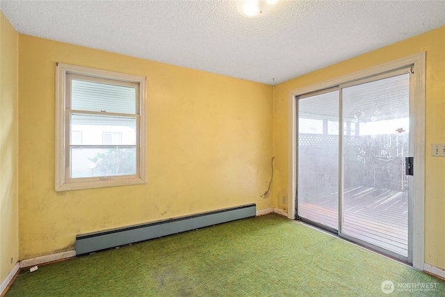 8608 16th Ave SW, Seattle, WA 98106 - empty room with baseboard heating, carpet flooring, and a textured ceiling