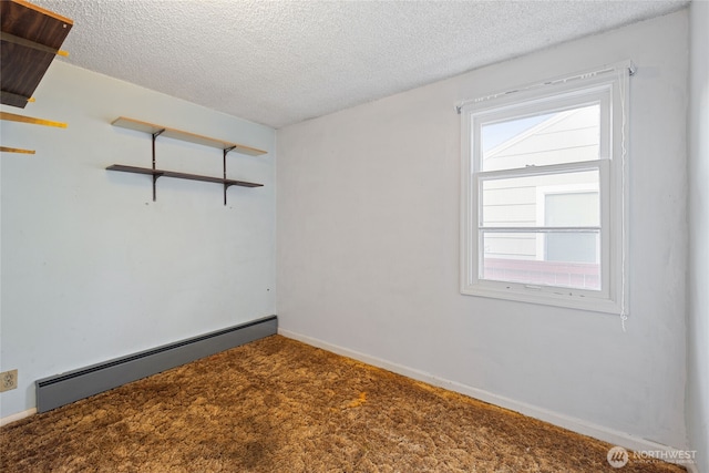 8608 16th Ave SW, Seattle, WA 98106 - carpeted empty room with baseboard heating and a textured ceiling