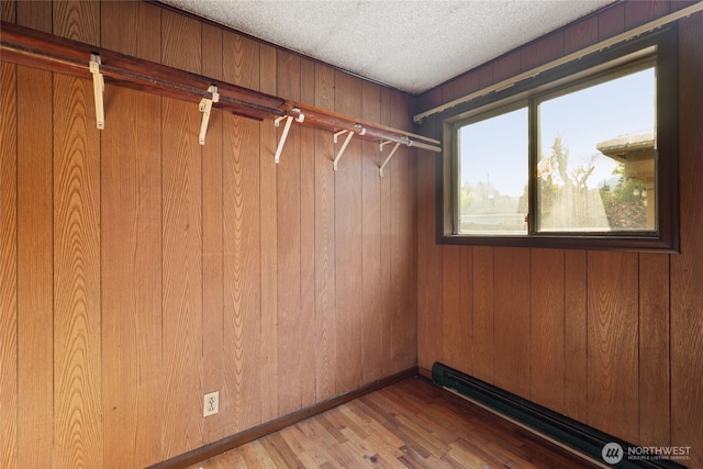 8608 16th Ave SW, Seattle, WA 98106 - walk in closet with a baseboard radiator and wood finished floors