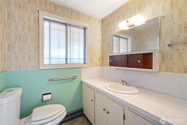 8608 16th Ave SW, Seattle, WA 98106 - half bath with vanity, wallpapered walls, and a baseboard radiator