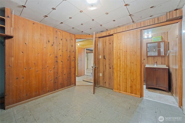 8608 16th Ave SW, Seattle, WA 98106 - unfurnished bedroom featuring tile patterned floors and wood walls