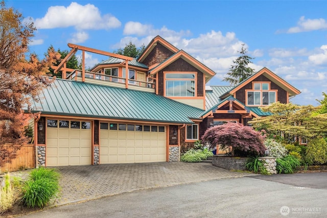 16375 NE 44th Ct, Redmond, WA 98052 - view of front of house with a standing seam roof, driveway, stone siding, and metal roof