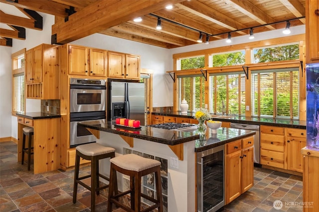 16375 NE 44th Ct, Redmond, WA 98052 - kitchen featuring track lighting, wine cooler, stainless steel appliances, plenty of natural light, and wood ceiling with exposed beams