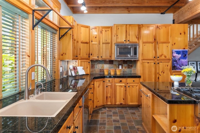 16375 NE 44th Ct, Redmond, WA 98052 - kitchen with a sink, stainless steel appliances, stone finish floors, plenty of natural light, and beamed ceiling