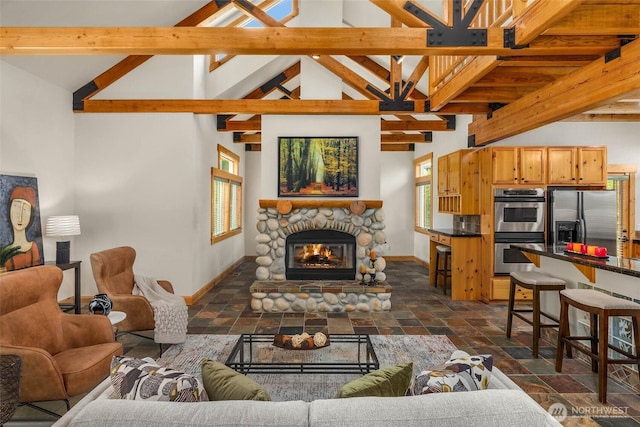 16375 NE 44th Ct, Redmond, WA 98052 - living room featuring stone tile flooring, plenty of natural light, baseboards, and a stone fireplace