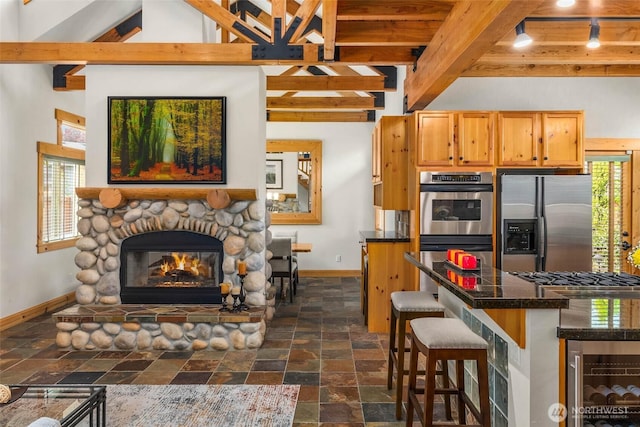 16375 NE 44th Ct, Redmond, WA 98052 - kitchen featuring stainless steel appliances, baseboards, stone tile flooring, wine cooler, and beam ceiling