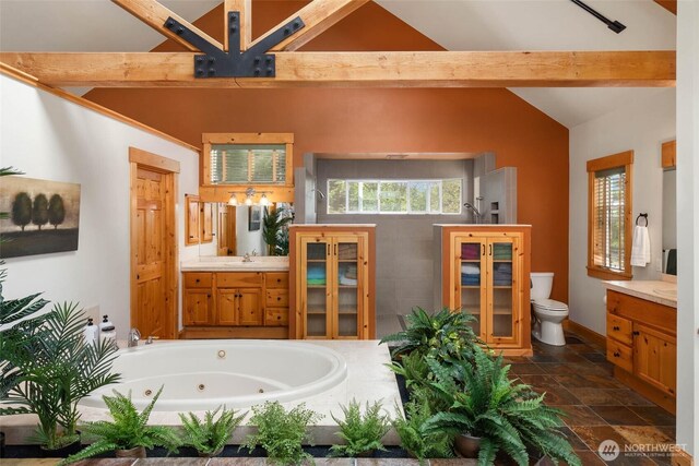 16375 NE 44th Ct, Redmond, WA 98052 - full bathroom featuring vanity, toilet, walk in shower, stone finish flooring, and a whirlpool tub
