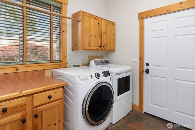 16375 NE 44th Ct, Redmond, WA 98052 - laundry room featuring washing machine and clothes dryer, cabinet space, and dark stone finish flooring