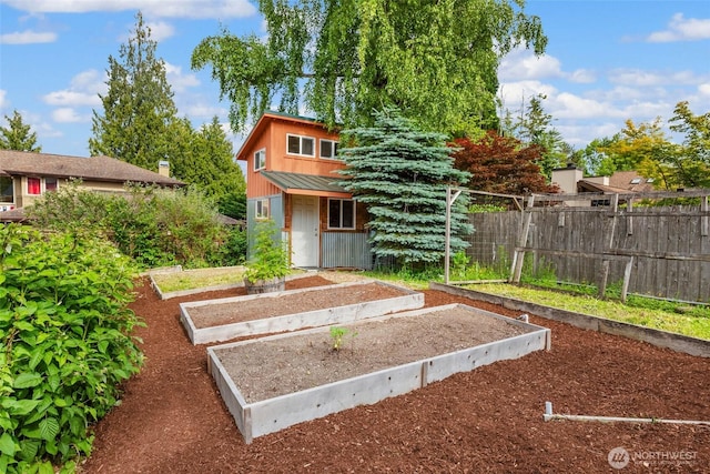 16375 NE 44th Ct, Redmond, WA 98052 - view of front of home featuring a garden, an outbuilding, and metal roof
