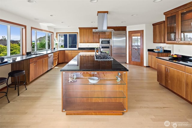 8533 NE Juanita Dr, Kirkland, WA 98034 - kitchen featuring built in appliances, island exhaust hood, a sink, a center island, and light wood-style flooring