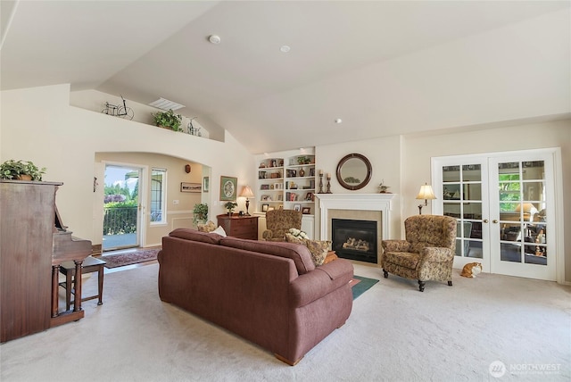 418 158th Pl NW, Arlington, WA 98223 - living area with carpet, lofted ceiling, a glass covered fireplace, built in features, and french doors