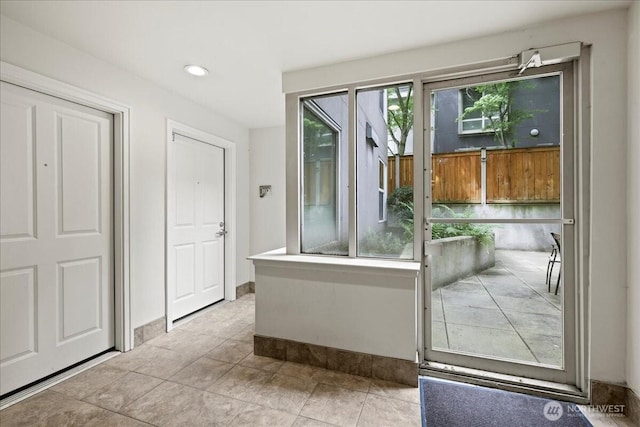4343 Roosevelt Way NE Unit 102, Seattle, WA 98105 - doorway to outside featuring tile patterned flooring, recessed lighting, and baseboards