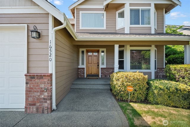 16520 136th Ave E, Puyallup, WA 98374 - doorway to property featuring a garage, brick siding, and a shingled roof