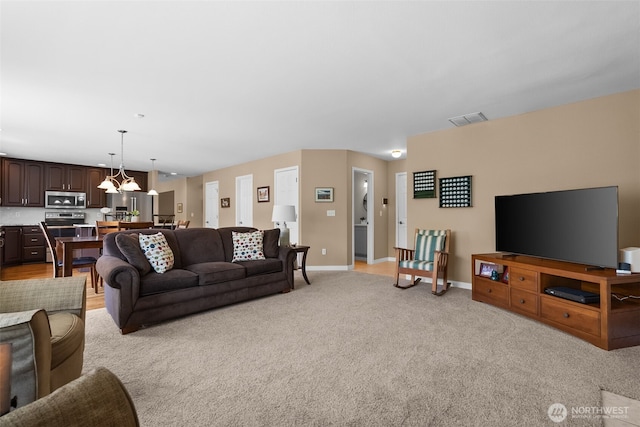 16520 136th Ave E, Puyallup, WA 98374 - living area with baseboards, light carpet, and a chandelier