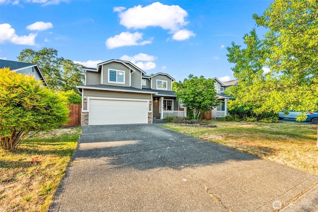 15235 105th Ave SE, Yelm, WA 98597 - traditional home with driveway, an attached garage, a porch, and stone siding