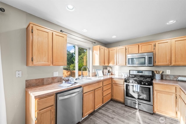15235 105th Ave SE, Yelm, WA 98597 - kitchen with stainless steel appliances, light brown cabinetry, light wood-type flooring, light countertops, and recessed lighting