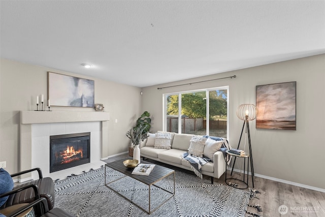 15235 105th Ave SE, Yelm, WA 98597 - living room featuring wood finished floors and a tile fireplace