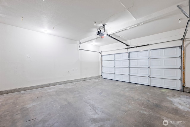 15235 105th Ave SE, Yelm, WA 98597 - garage with baseboards and a garage door opener