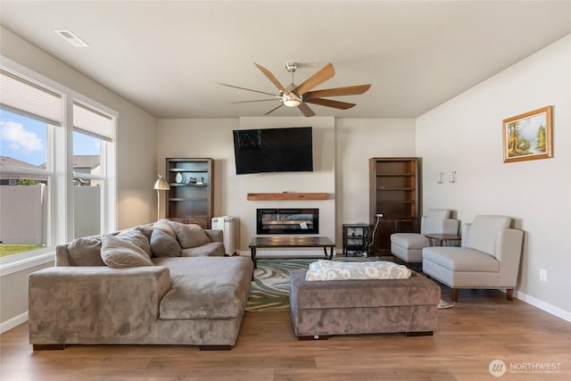 707 I St NE, Quincy, WA 98848 - living area with ceiling fan, a glass covered fireplace, plenty of natural light, and baseboards