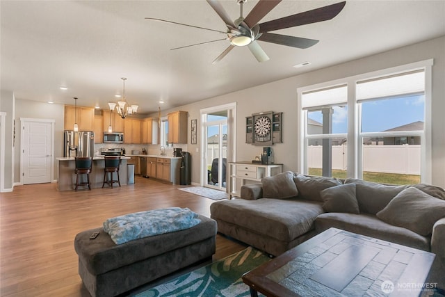 707 I St NE, Quincy, WA 98848 - living room featuring a chandelier, a ceiling fan, wood finished floors, recessed lighting, and baseboards