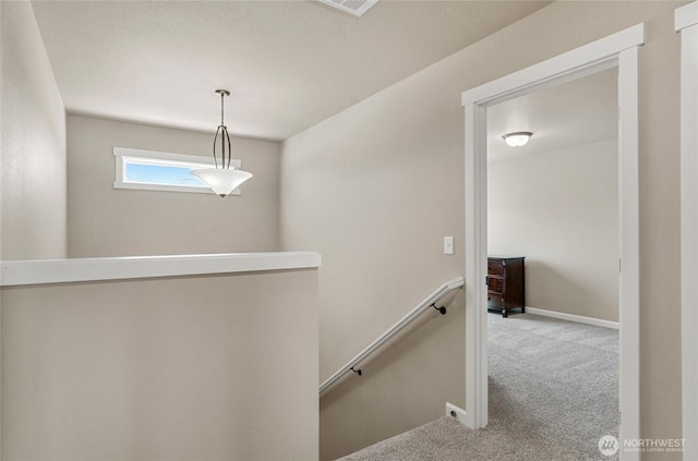 707 I St NE, Quincy, WA 98848 - hallway featuring an upstairs landing, carpet floors, and baseboards