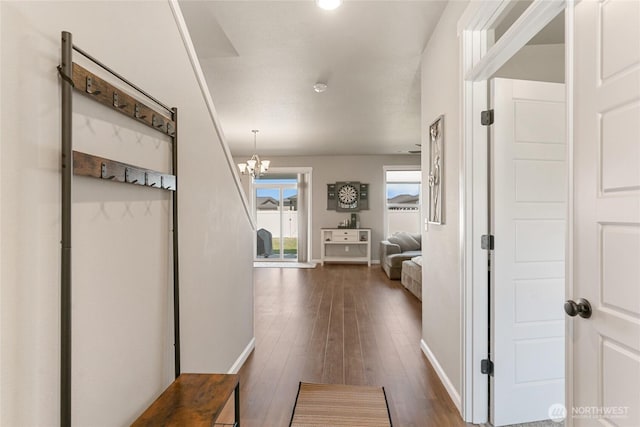 707 I St NE, Quincy, WA 98848 - corridor with baseboards, a chandelier, and dark wood-style floors