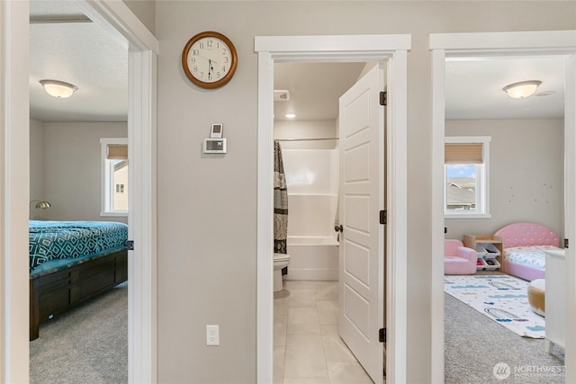 707 I St NE, Quincy, WA 98848 - hallway featuring light colored carpet, light tile patterned flooring, and baseboards