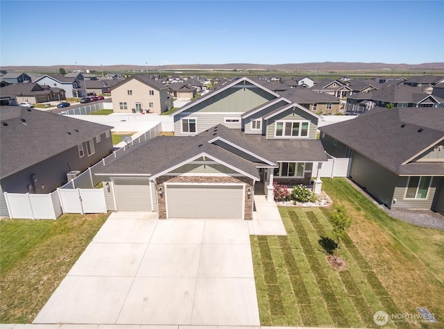 707 I St NE, Quincy, WA 98848 - view of front facade featuring a residential view, concrete driveway, and an attached garage