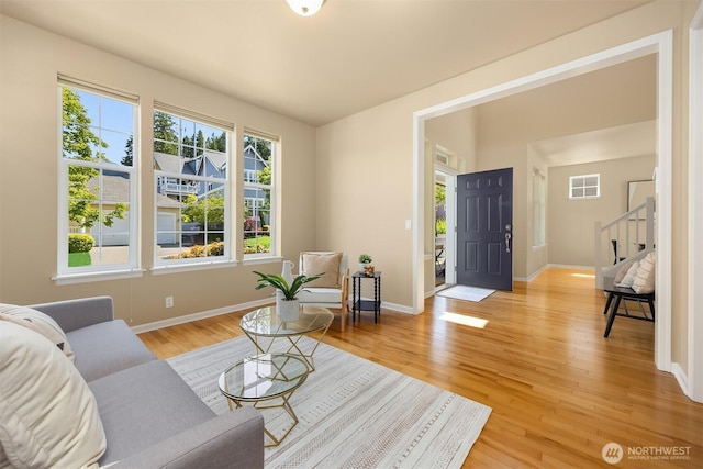 19799 NE Ash Crest Loop, Poulsbo, WA 98370 - living area with light wood-type flooring, baseboards, and stairway